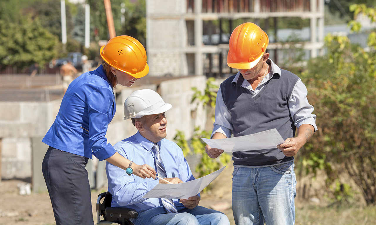 Disabled person in the construction helmet with documents in han Aspiria